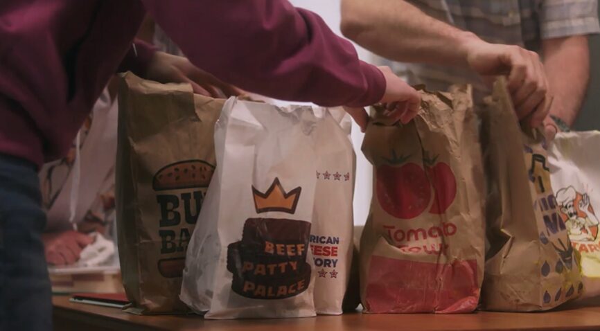 Family placing takeout food bags on dining table before meal