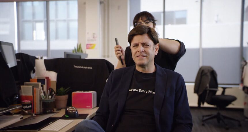 man getting his hair don in an office for splunk commercial