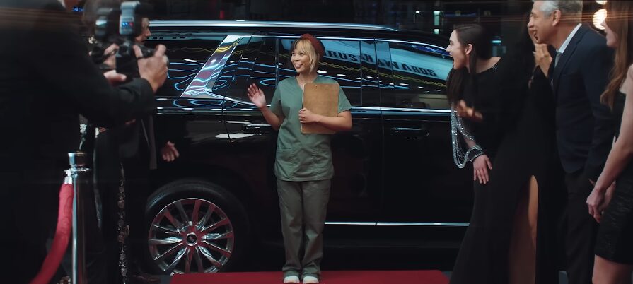 business owner at a red carpet event in scrubs for semrush commercial