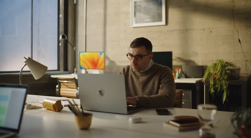 Man working on a laptop in an office for SurveyMonkey Commercial