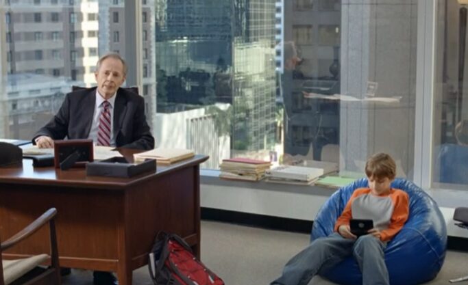 Old man and young boy in an office for fedex commercial