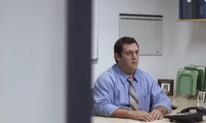 man staring at nothing in an office for fedex commercial