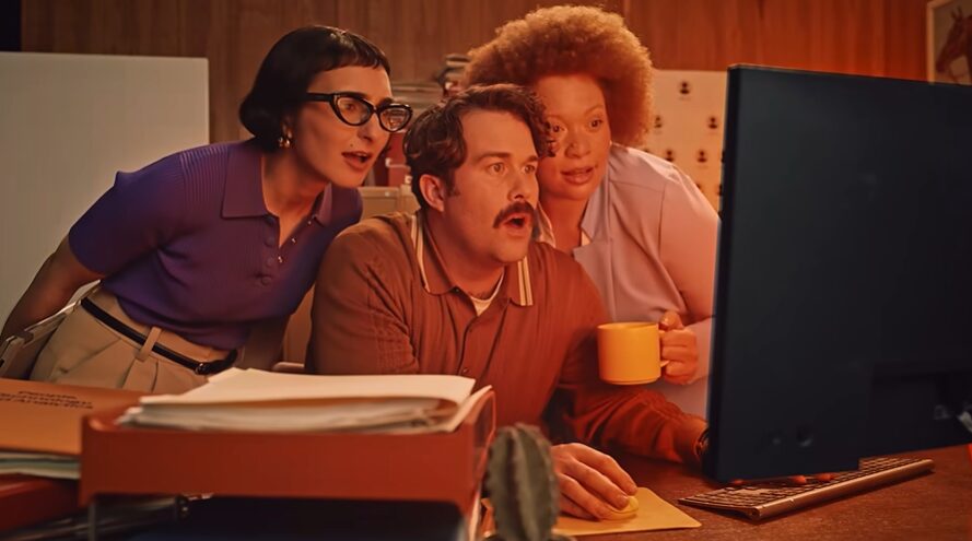 three professionals in front of a computer for Deel commercial