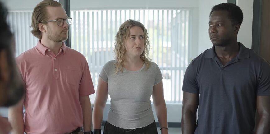 Three professionals looking at each other in Skedda commercial