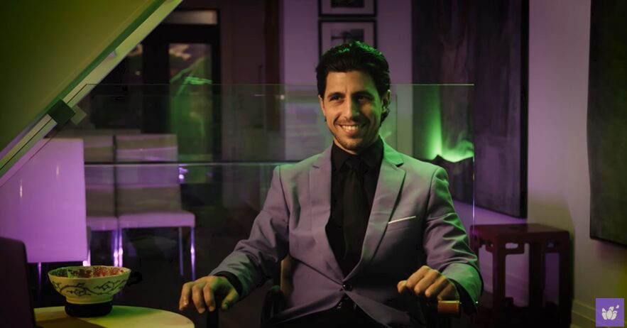 man in a purple suit in a dim lit office