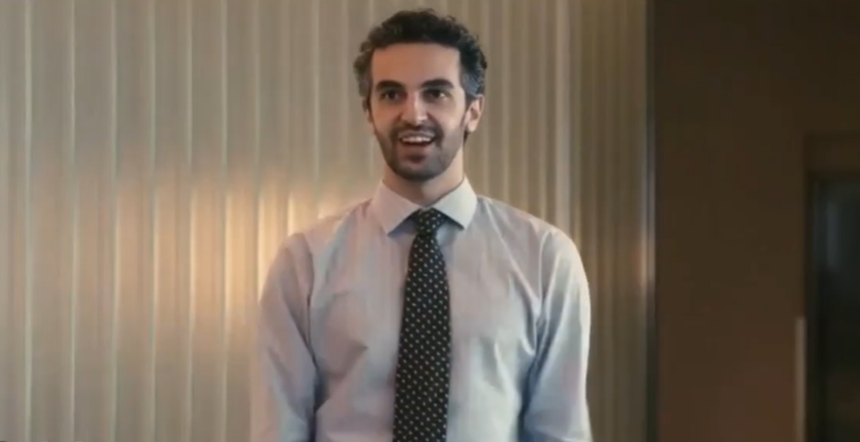 Man smiling in a boardroom meeting for Workday commercial