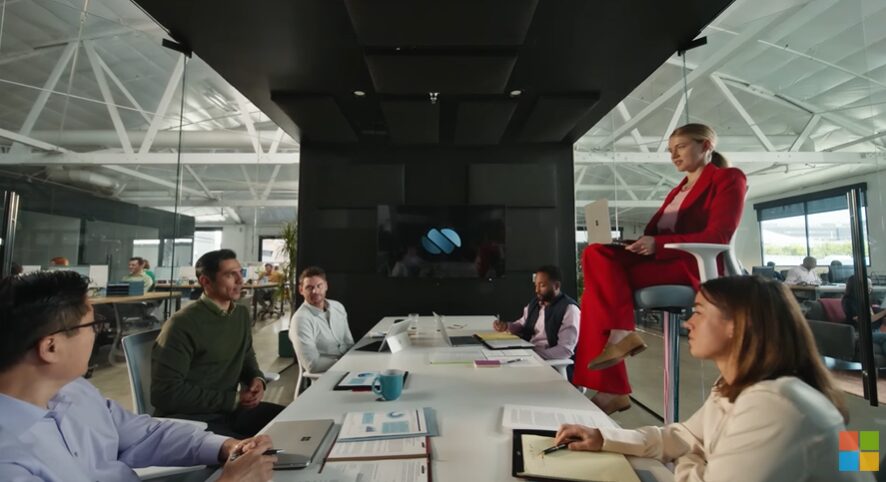 Professionals in a boardroom meeting for Microsoft commercial